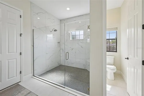 a bathroom with a glass shower door