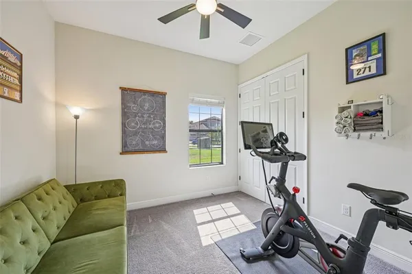 a view of a workspace with furniture and a window