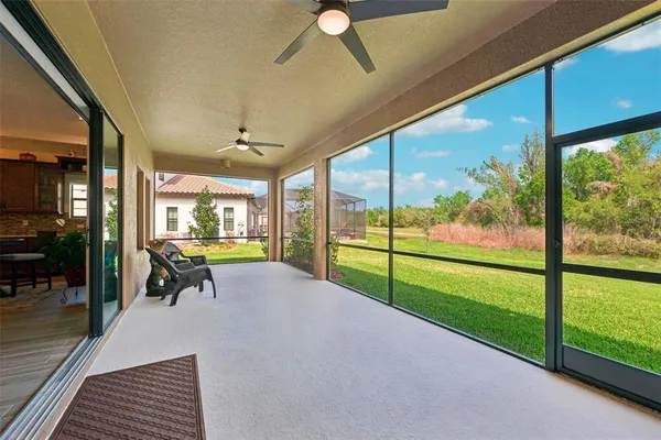 a view of a porch with chairs and backyard