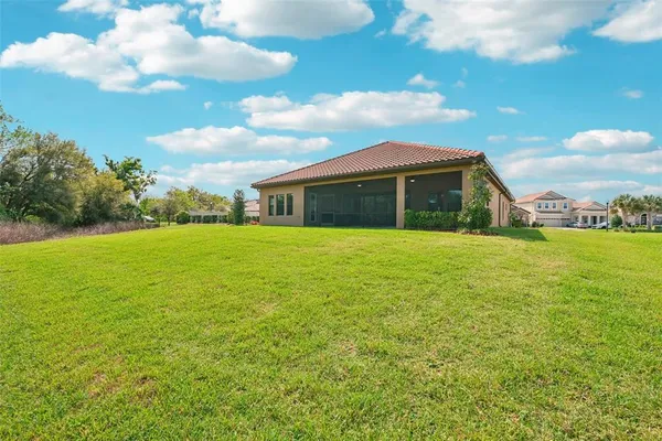 a front view of a house with a garden and plants