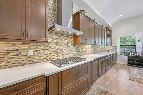 a kitchen with stainless steel appliances granite countertop a stove a sink and a white cabinets