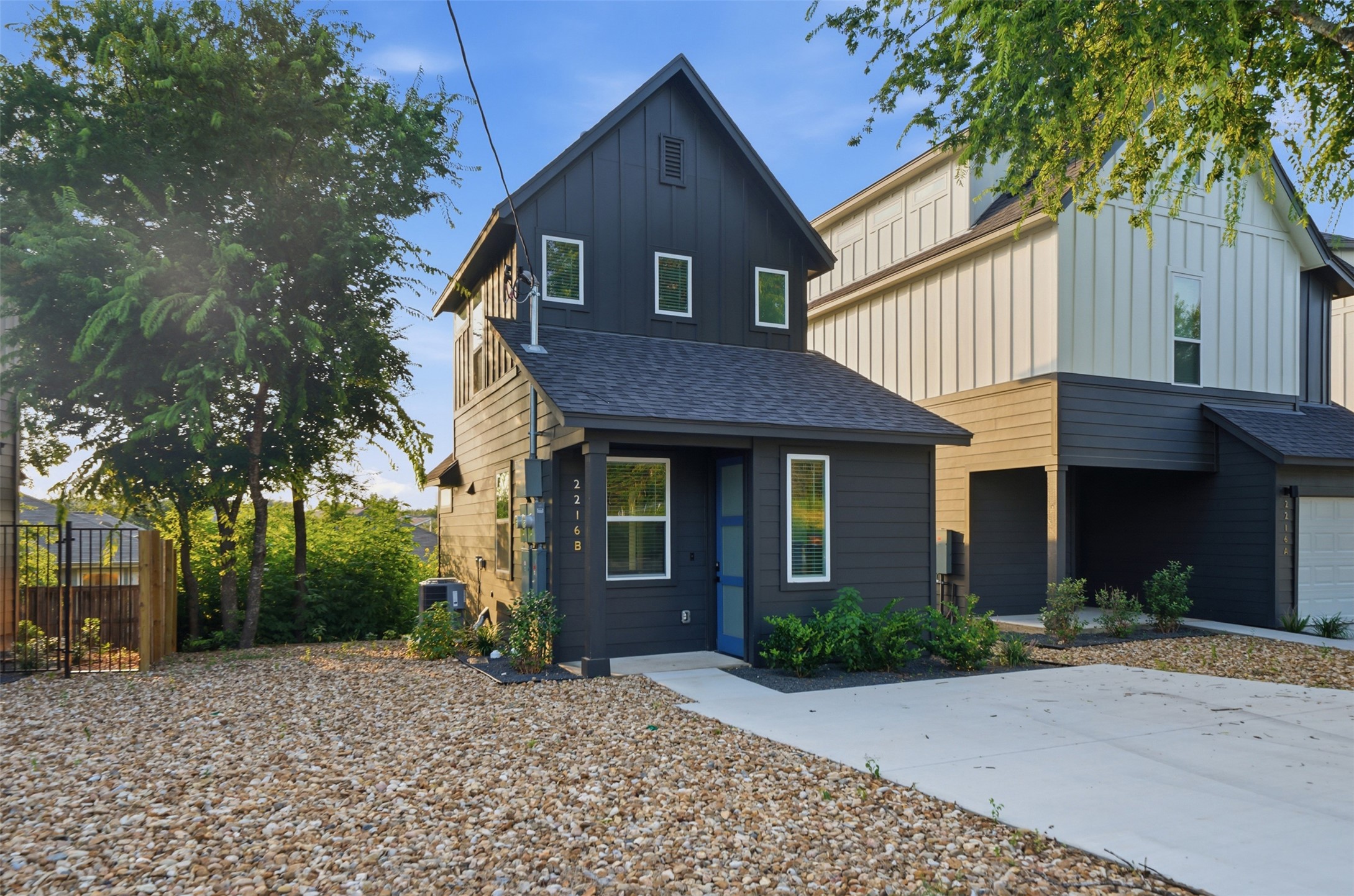 2216 Yellow Jacket Lane, Unit 2 Austin, TX 78741 - Photo 1 of 25 a front view of a house with a garden