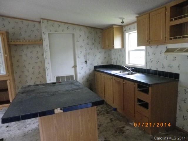1978 Steel Hill Road Van Wyck, SC 29720 - Photo 3 of 9 a kitchen with granite countertop a stove and a sink