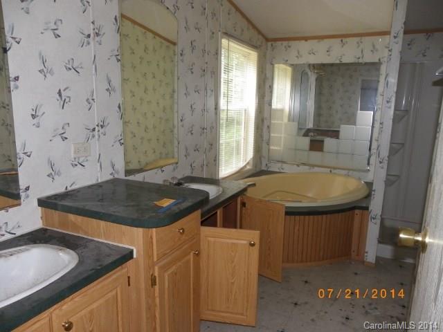 1978 Steel Hill Road Van Wyck, SC 29720 - Photo 5 of 9 a bathroom with a granite countertop sink and a mirror