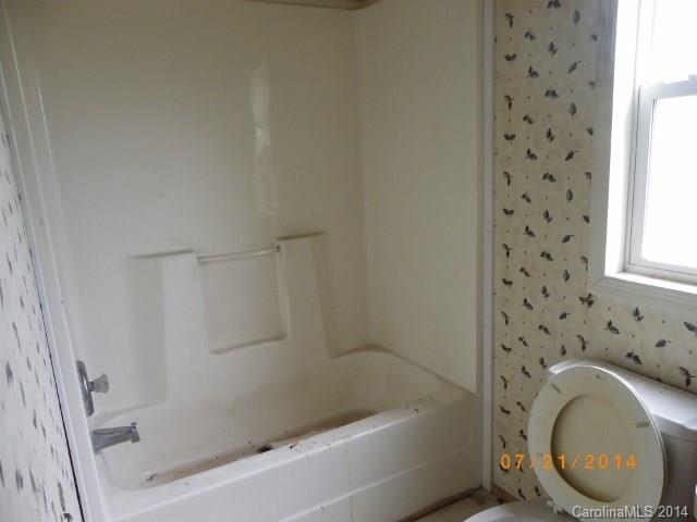 1978 Steel Hill Road Van Wyck, SC 29720 - Photo 7 of 9 a bathroom with a granite countertop sink a toilet and bathtub