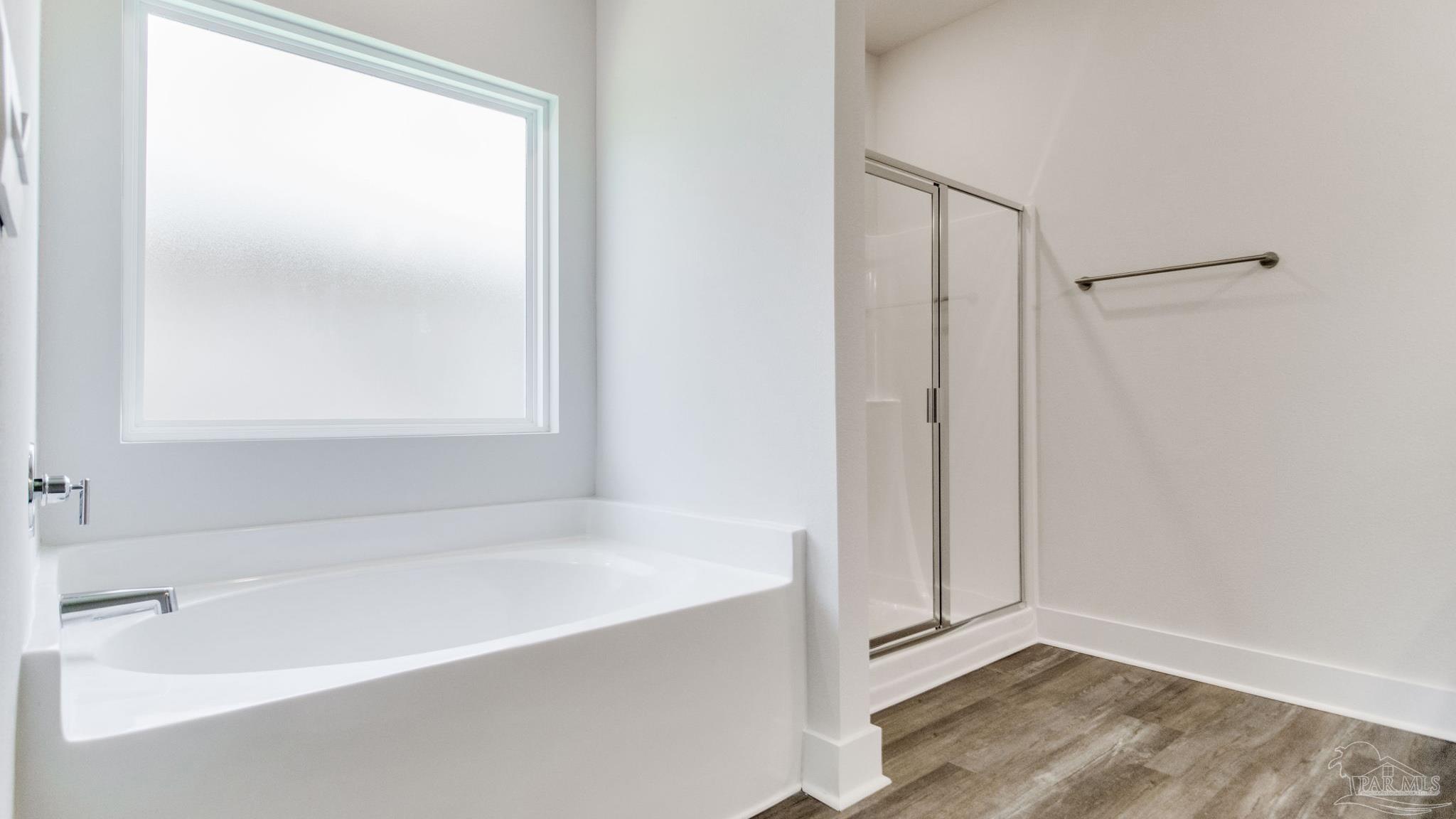 3034 Serviceberry Road Cantonment, FL 32533 - Photo 17 of 33 a bathroom with a bathtub and a shower