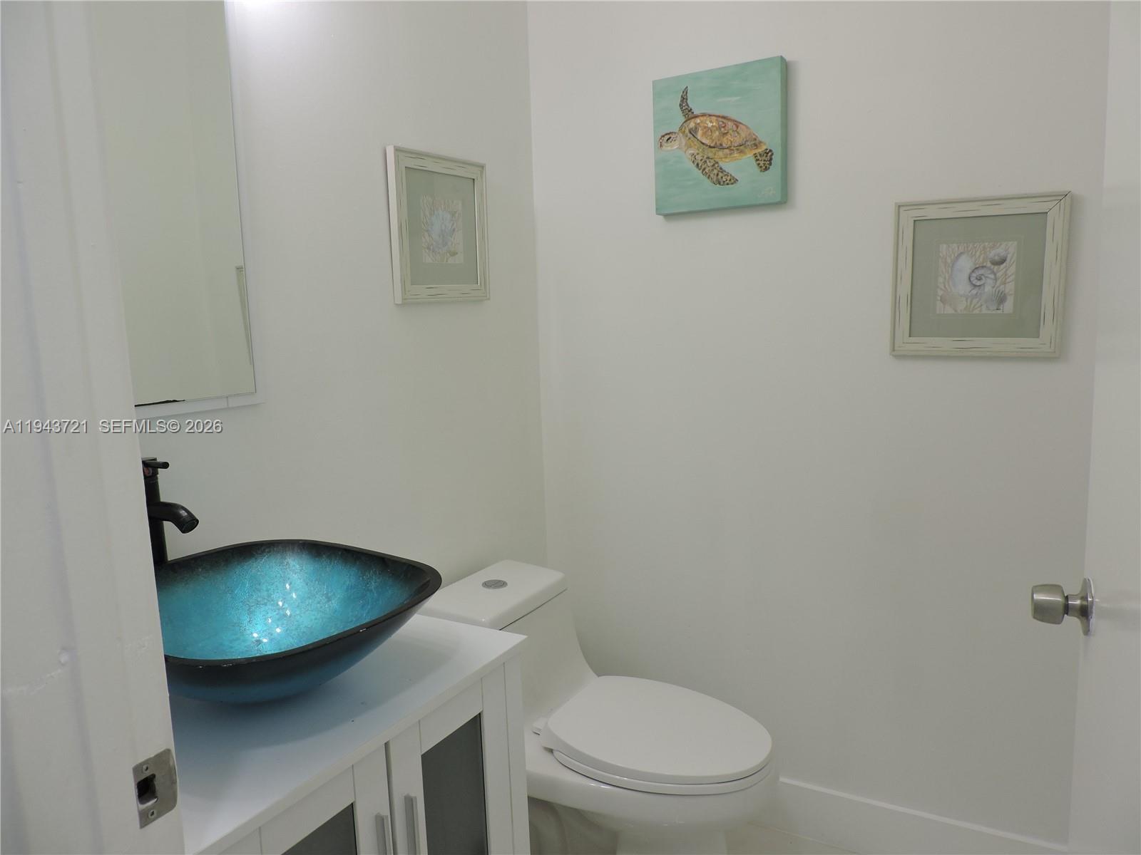 17975 Southwest 140th Court, Unit 17975 Miami, FL 33177 - Photo 14 of 27 a bathroom with a toilet and a sink