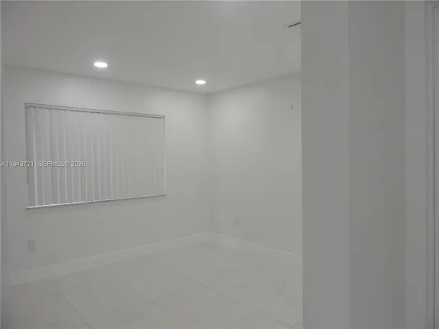 a kitchen with stainless steel appliances a refrigerator sink and white cabinets