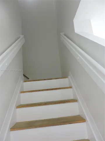 a white toilet sitting next to a bath tub