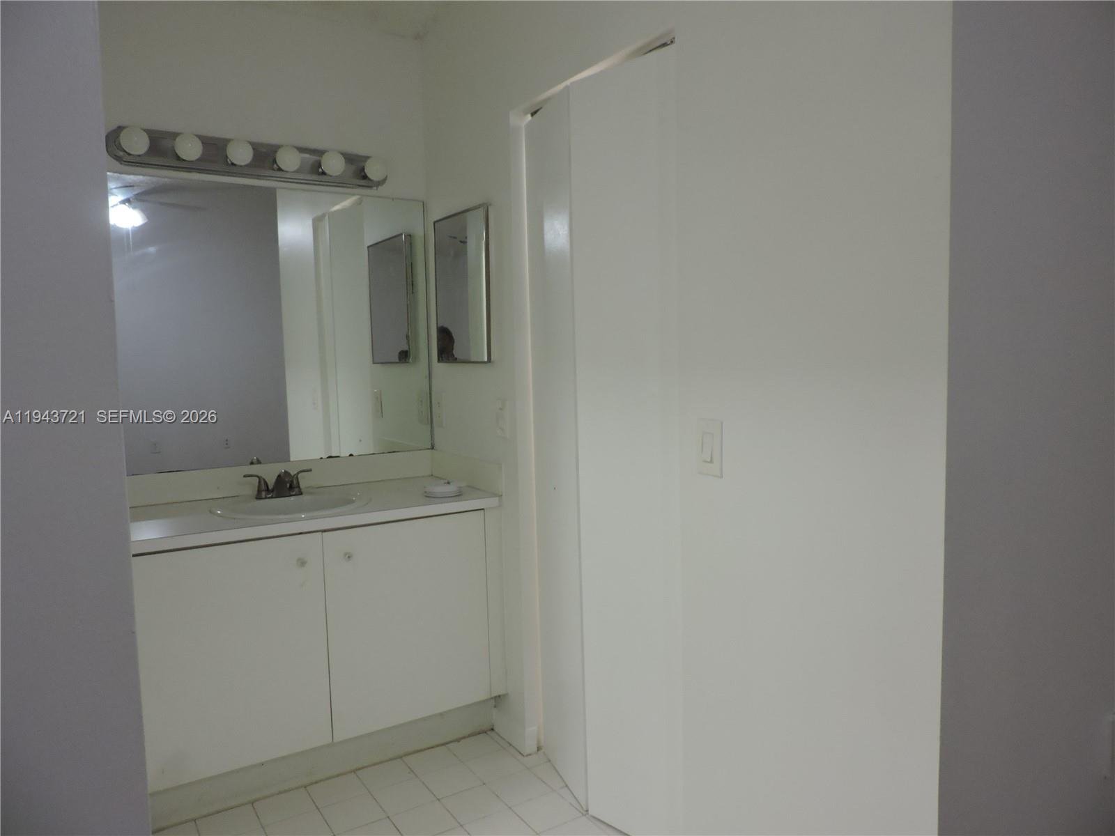 17975 Southwest 140th Court, Unit 17975 Miami, FL 33177 - Photo 22 of 27 a bathroom with a granite countertop sink a toilet and mirror