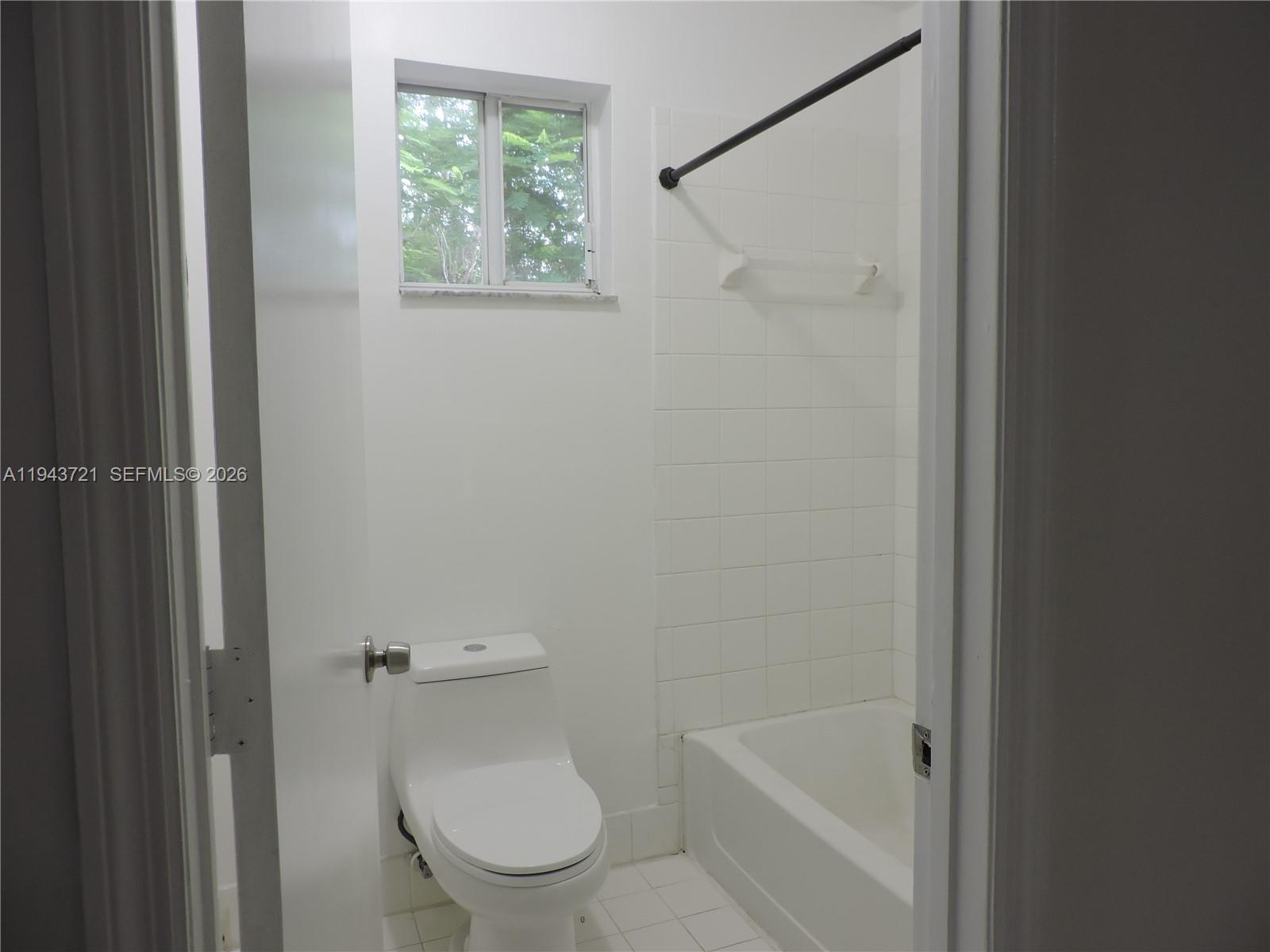 17975 Southwest 140th Court, Unit 17975 Miami, FL 33177 - Photo 23 of 27 a white toilet sitting next to a bath tub