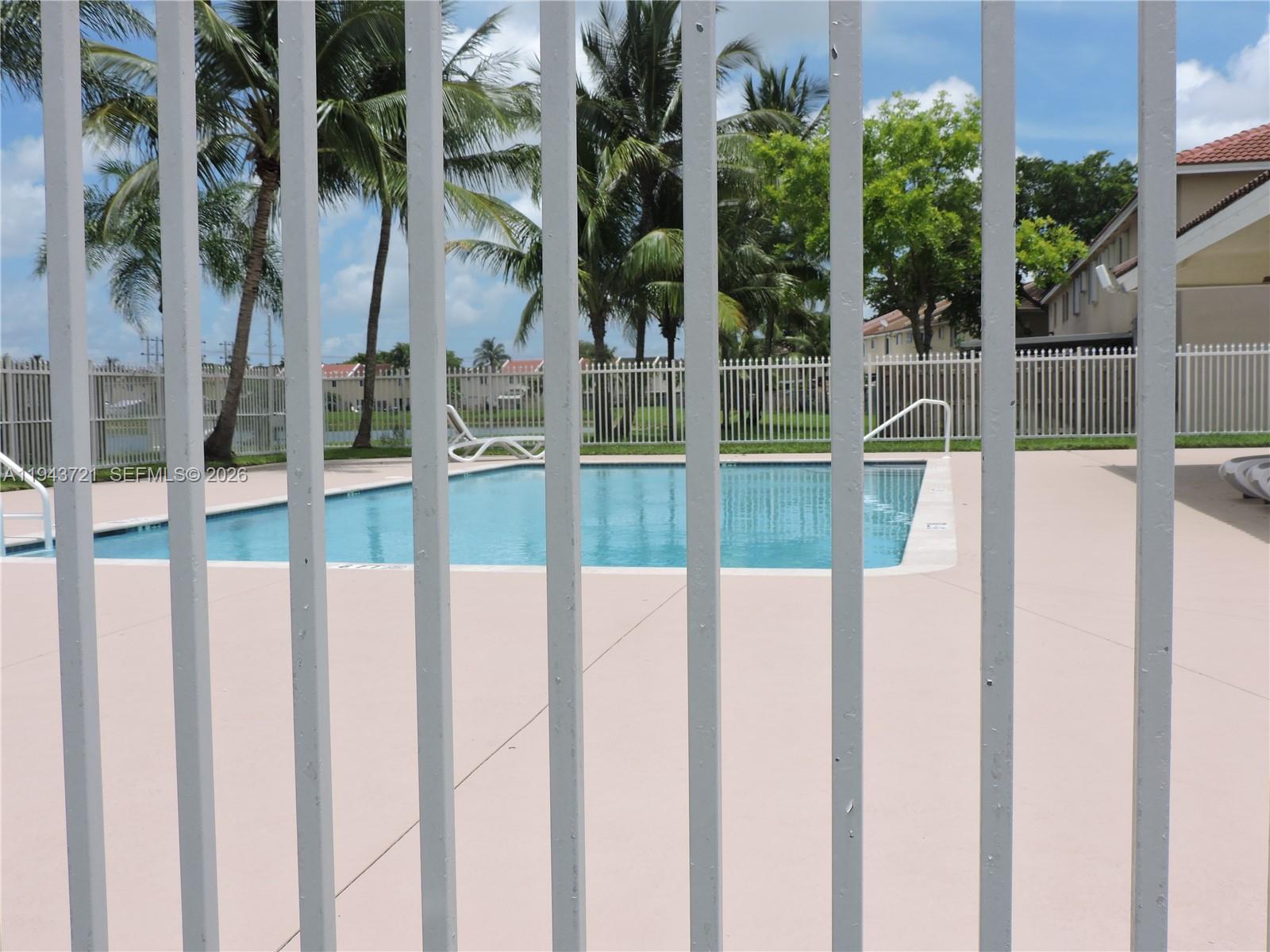 17975 Southwest 140th Court, Unit 17975 Miami, FL 33177 - Photo 9 of 27 a view of a house with a floor to ceiling windows and palm tree