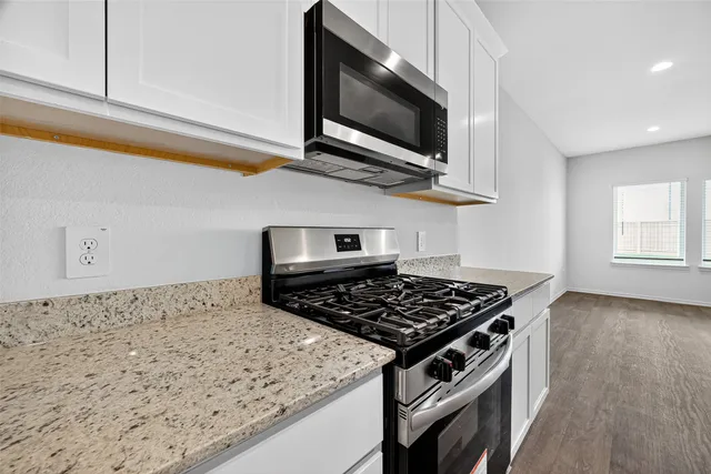 a kitchen with a stove and a microwave