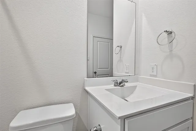 a bathroom with a sink toilet and vanity