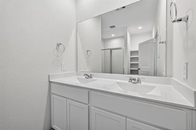 a bathroom with a sink double vanity and a mirror