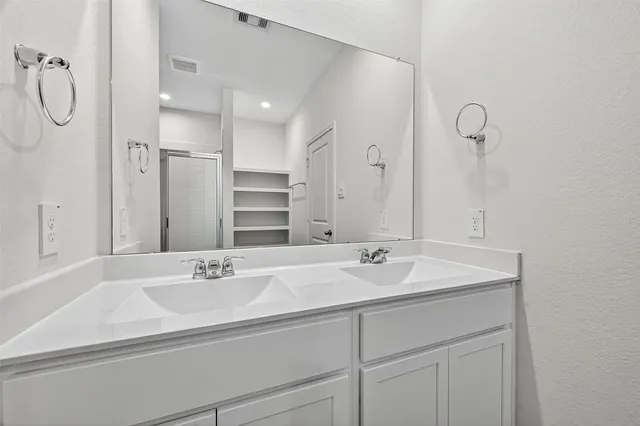 a bathroom with a glass shower door