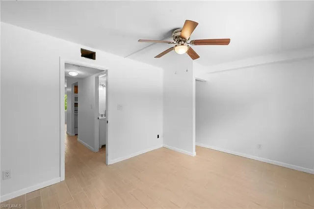 a view of a big room with closet and a ceiling fan