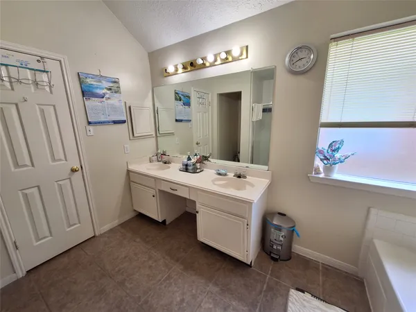 a bedroom with furniture and a flat screen tv