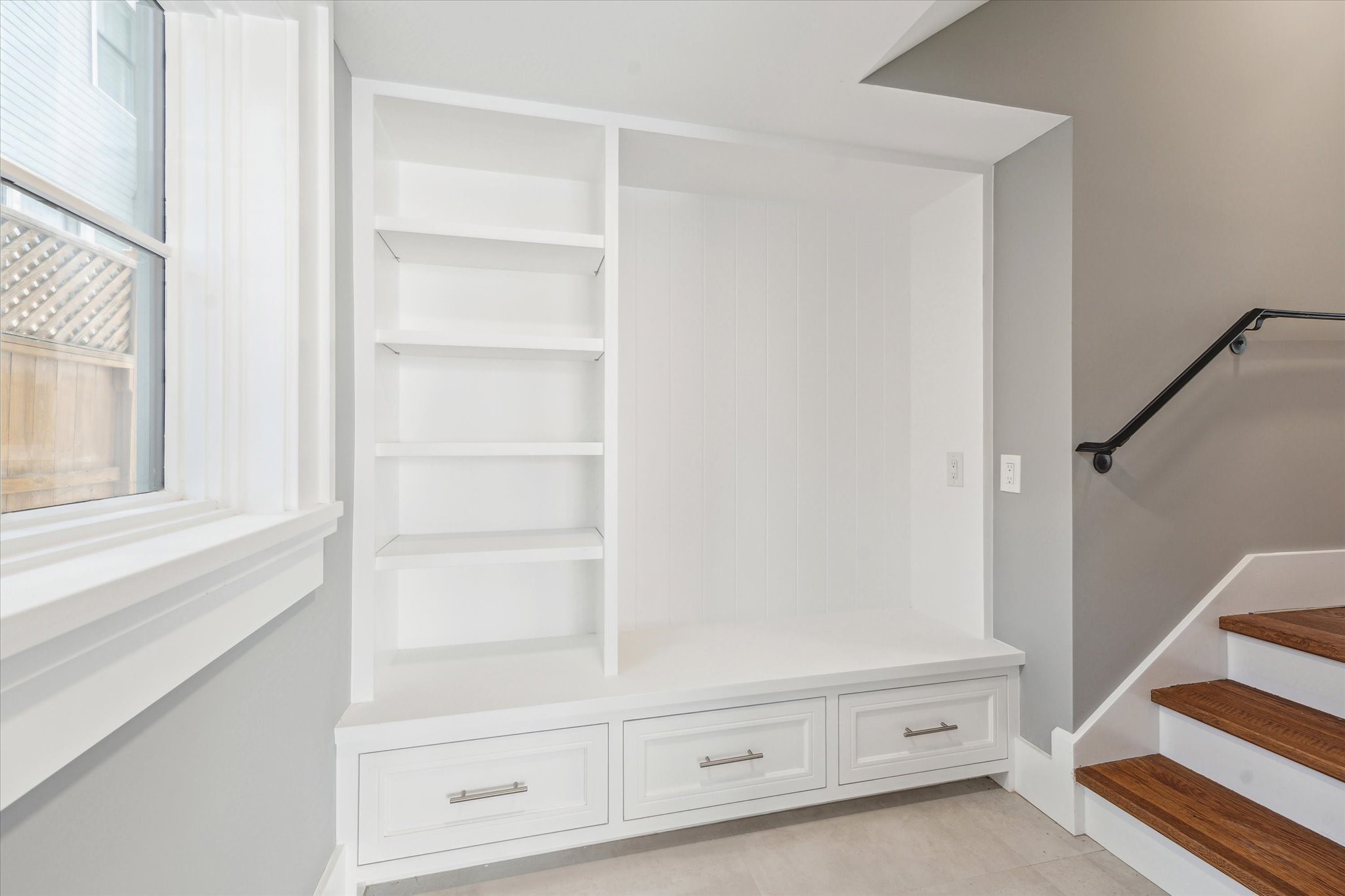 2216 Tangley Street Houston, TX 77005 - Photo 25 of 44 This is the back entrance from the garage and has a built-in white bench with storage drawers and shelves, located next to a window--ideal for leaving backpack, etc before you enter the house.