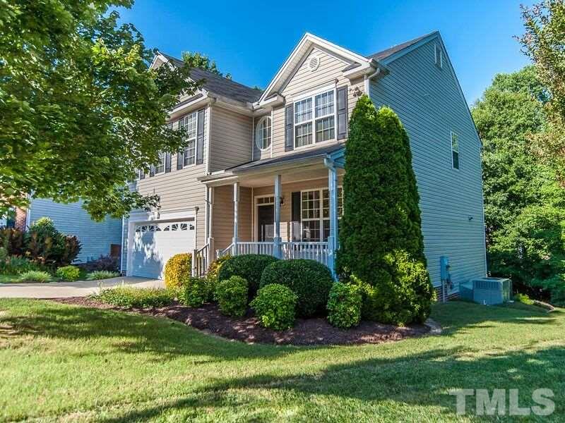 4728 Drewbridge Way Raleigh, NC 27604 - Photo 1 of 15 a front view of a house with a yard and garage