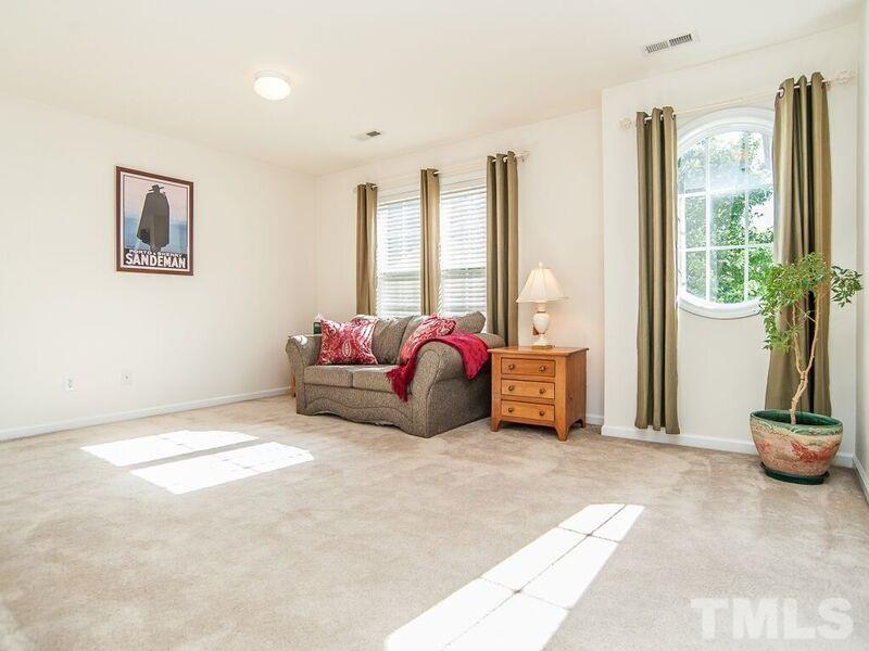 4728 Drewbridge Way Raleigh, NC 27604 - Photo 3 of 15 a living room with furniture toys and a large window