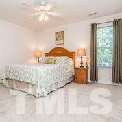 4728 Drewbridge Way Raleigh, NC 27604 - Photo 6 of 15 a bedroom with a bed and window