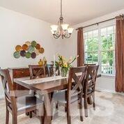 4728 Drewbridge Way Raleigh, NC 27604 - Photo 9 of 15 a view of a dining room with furniture a chandelier and wooden floor