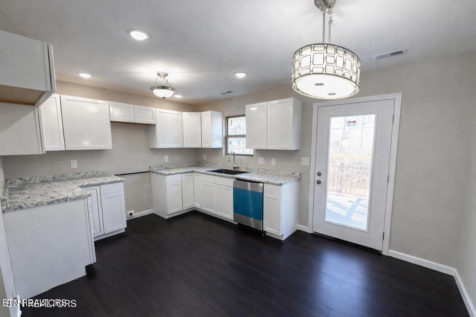 501 Hillcrest Street Clinton, TN 37716 - Photo 2 of 8 a kitchen with stainless steel appliances granite countertop a sink a stove a microwave and cabinets