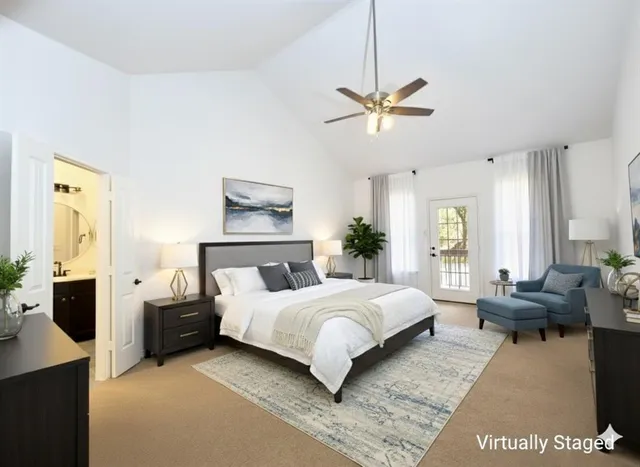 a bedroom with a large bed couch and a window