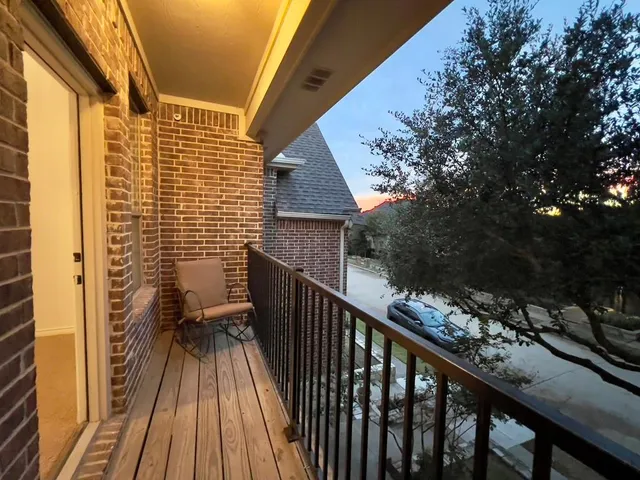 a view of balcony with wooden floor and fence