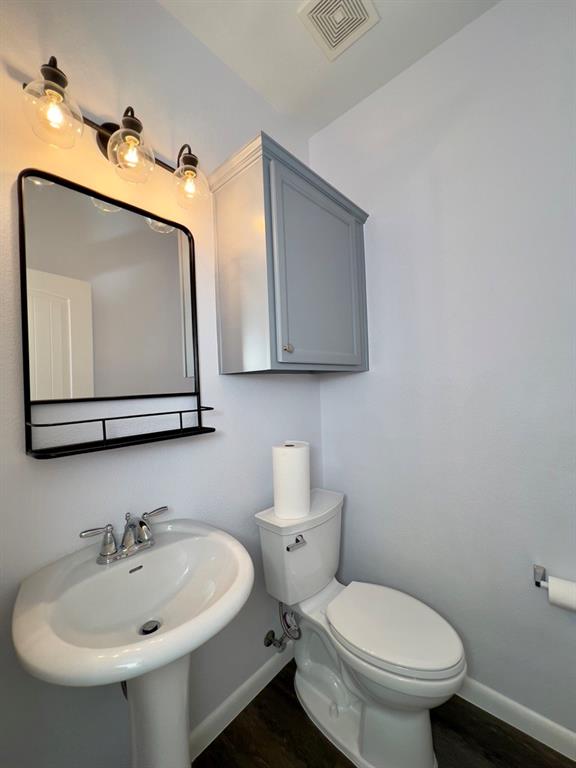 1902 Downing Street Allen, TX 75013 - Photo 8 of 19 Bathroom with dark wood-style floors and baseboards