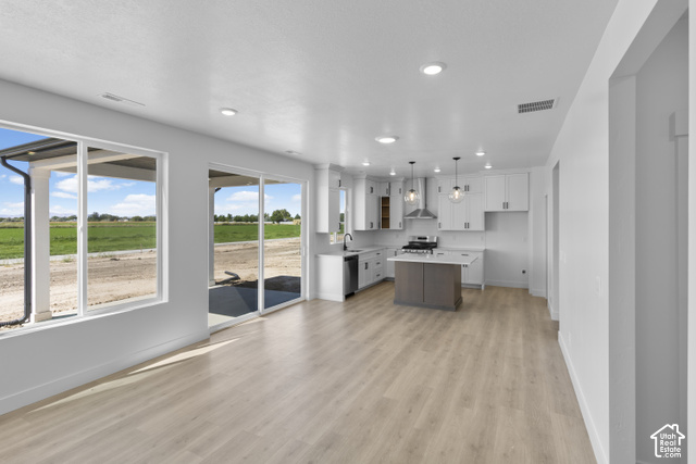 537 South 1150 West Logan, UT 84321 - Photo 6 of 33 Open-concept living space with wood-finish flooring, recessed lighting, and large windows