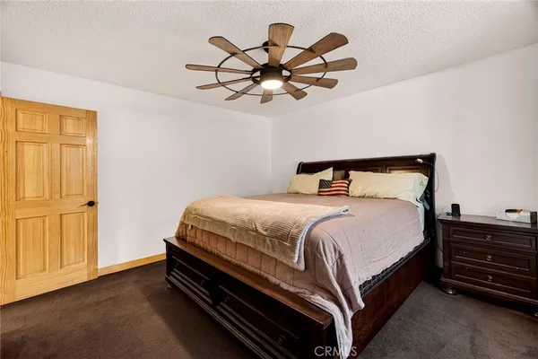 a view of a room with a ceiling fan