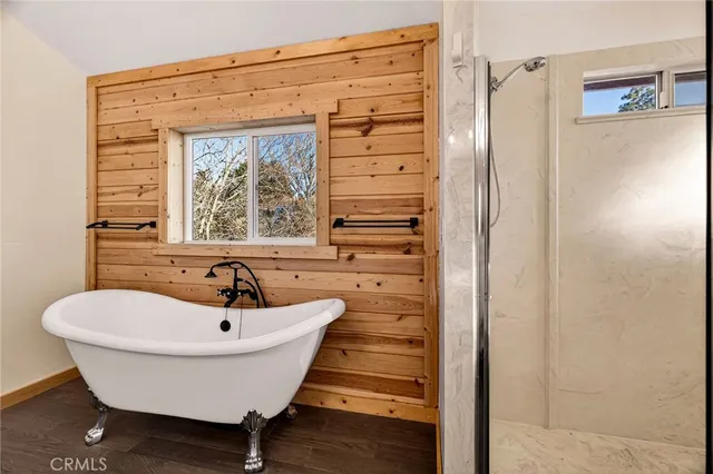 an aerial view of a city with lots of residential buildings ocean and mountain view in back