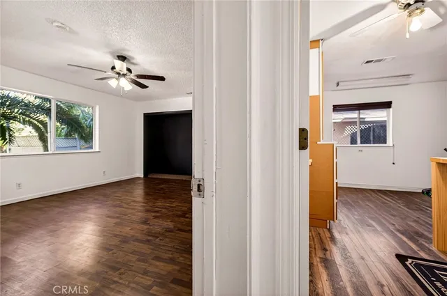 an aerial view of a city with lots of residential buildings ocean and mountain view in back