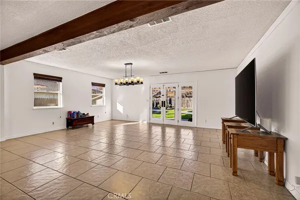 a view of a livingroom with furniture and an empty room