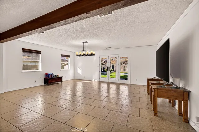 a view of a livingroom with furniture and an empty room