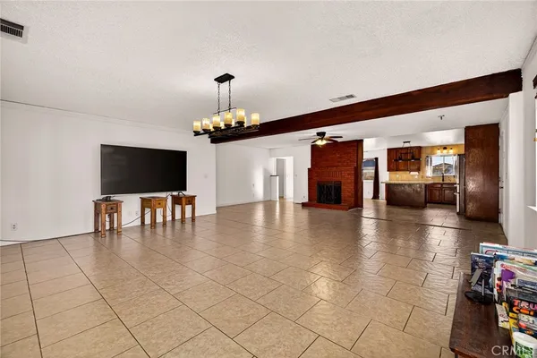 a kitchen with granite countertop a refrigerator and a stove top oven