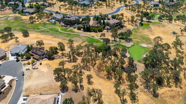 an aerial view of residential houses with outdoor space and river