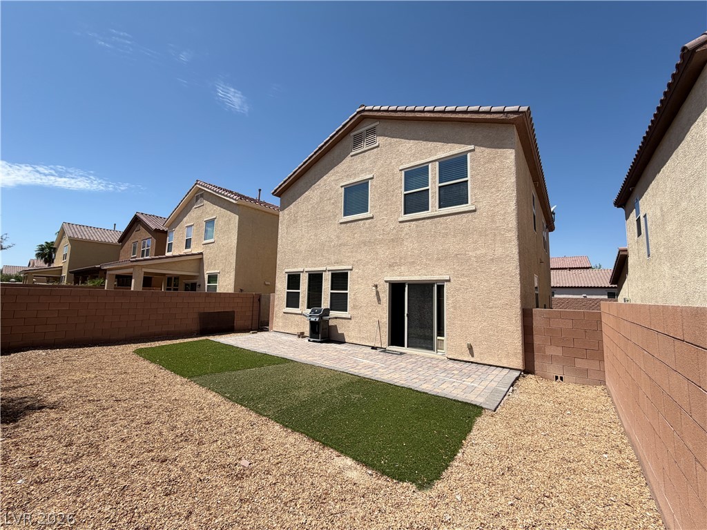 442 White Heart Road Las Vegas, NV 89148 - Photo 24 of 25 A paved patio and tidy yard complement the stucco exterior of this multi-level home.