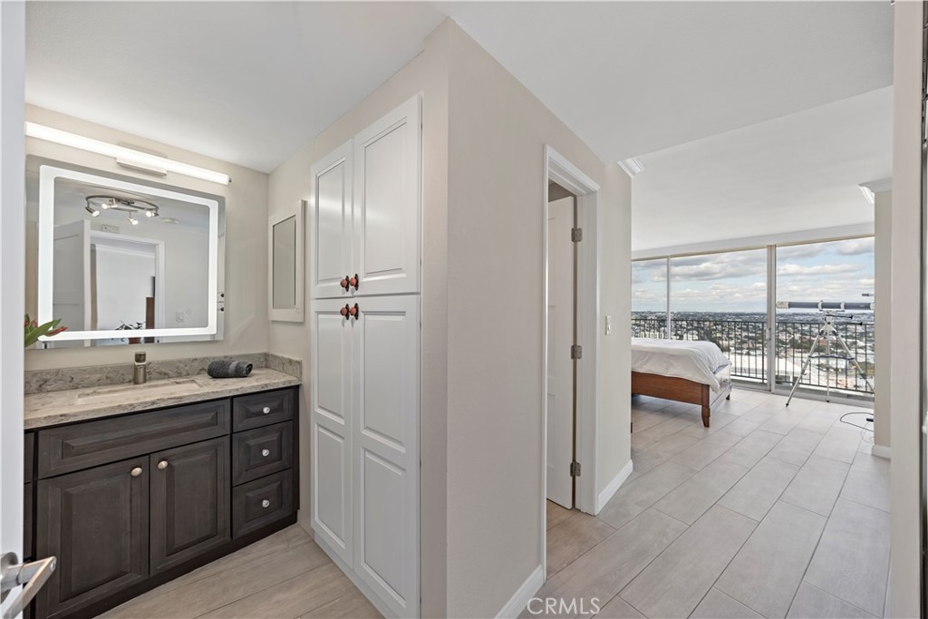 700 East Ocean Boulevard, Unit 3003 Long Beach, CA 90802 - Photo 15 of 35 a spacious bathroom with a granite countertop sink a mirror and a shower