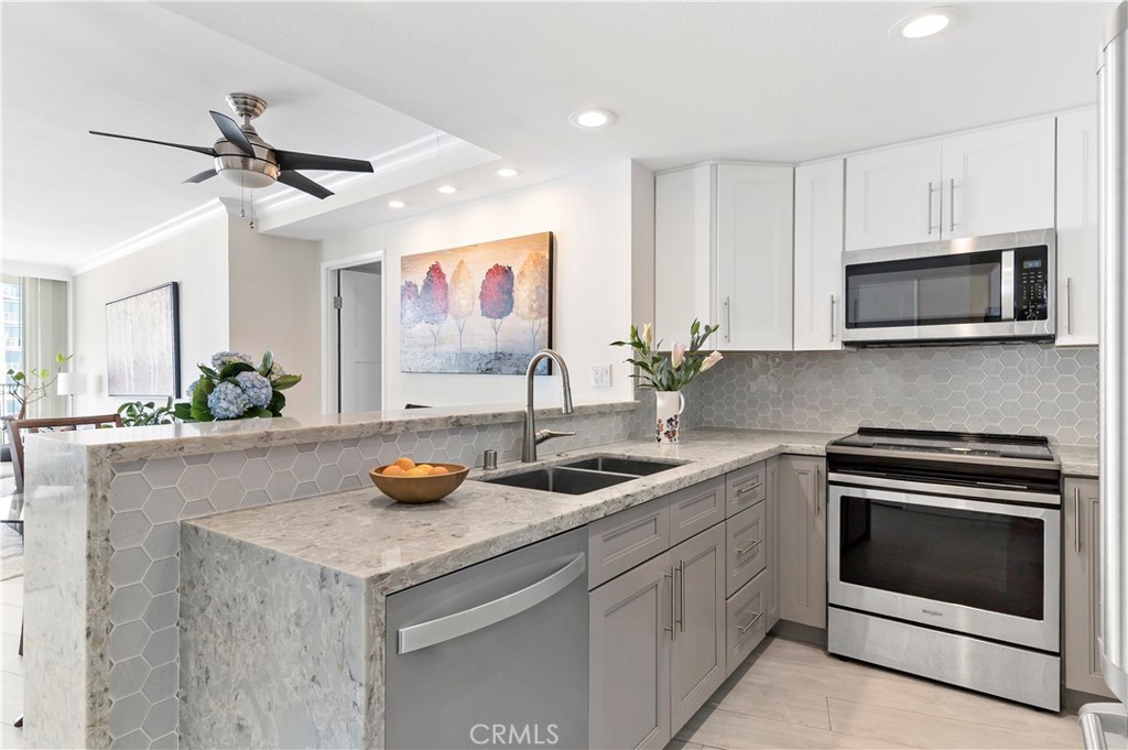 700 East Ocean Boulevard, Unit 3003 Long Beach, CA 90802 - Photo 8 of 35 a kitchen with stainless steel appliances a stove sink and microwave