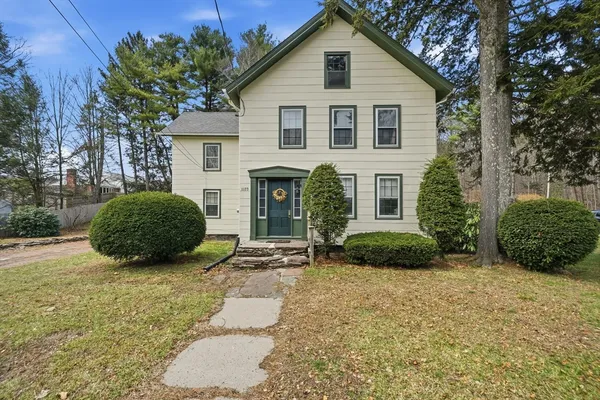 a view of a house with a yard and garage