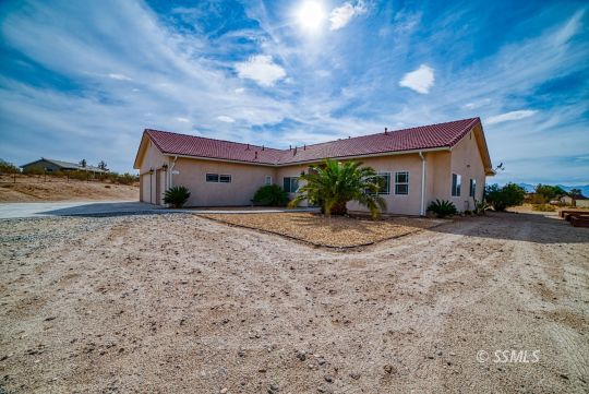 411 North Nolan Street Ridgecrest, CA 93555 - Photo 31 of 43 a front view of house with yard and car parked