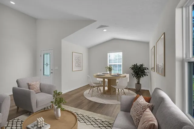 a living room with furniture potted plant and a window