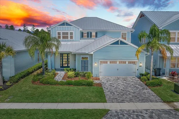 a front view of a house with a garden