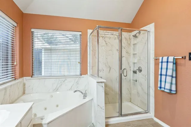 a bathroom with a bathtub and a shower