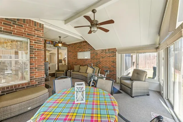 a bedroom with a bed couch and a window