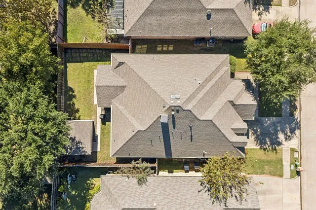 an aerial view of a house with a yard
