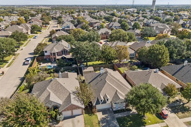 an aerial view of residential houses with outdoor space